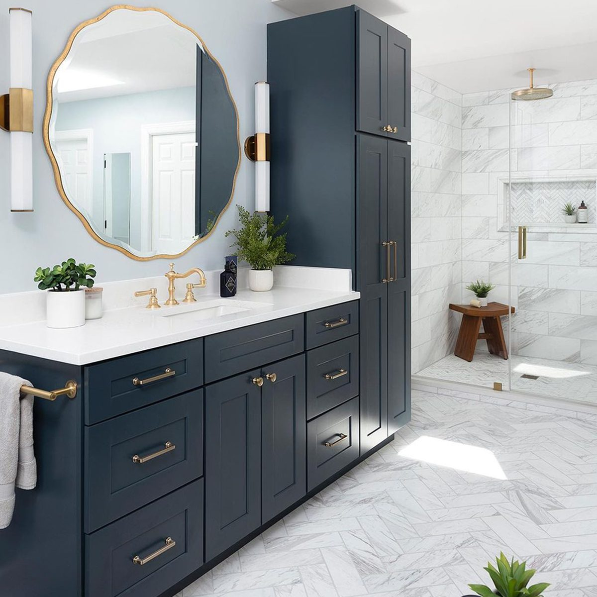 Creating a Spa-Like Bathroom with Dark Blue Vanity and Carrara Countertop